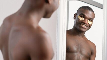 Metrosexual morning. Home spa. Confident happy satisfied shirtless man with toothy smile and gold...