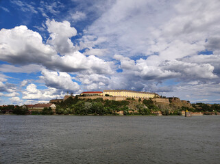Fototapeta na wymiar Petrovaradin fortress with blue sky and white clouds seen from Novi Sad 