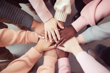 Obraz na płótnie Canvas Group of mix race people joining hands together in a circle supporting each other, symbolizing unity