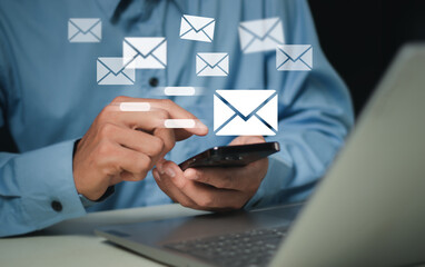 Businessman sending email by laptop computer to customer, business contact and communication, email icon, email marketing concept, send e-mail or newsletter, online working internet network..
