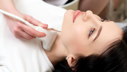 A doctor performs an ultrasound of the thyroid gland and cervical lymph nodes on a patient in a...