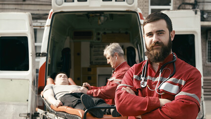 Close-up of a healthcare worker's face near an ambulance. The concept of saving a person's life and...