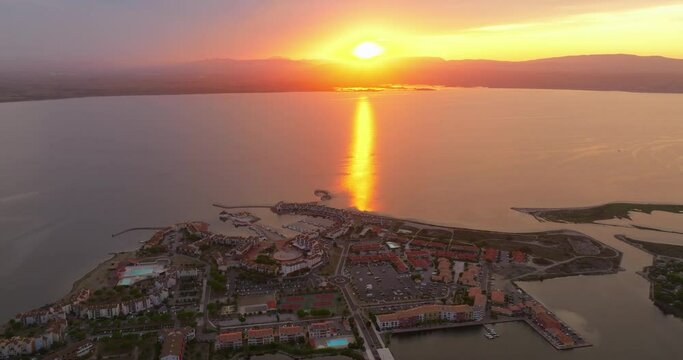 Drone view of the Leucate tourist spot on the Mediterranean Sea, southern France, in summer, during the height of the tourist season. Drone flies at a beautiful sunset