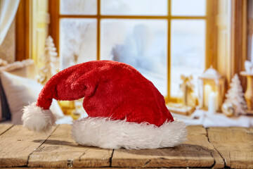 Fototapeta premium Red santa claus hat and winter window. 