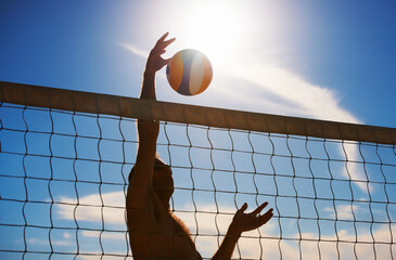 Volleyball, fitness and man at beach with ball serve, energy or freedom on blue sky background....