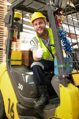 Warehouse worker wears safety helmet driving forklift truck in pallet factory. Skilled male logistic engineer working in shipping storage manufacturing lifting, moving and unloading cargo for delivery © Nassorn