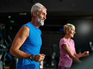 gym sport fitness exercising training mature man running cardio treadmill healthy active man adult...