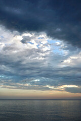 The sky is clearing up over the sea after the rain stopped. - obrazy, fototapety, plakaty