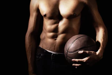 Fotobehang Muscle, body and hands of man with basketball in studio isolated on a black background. Sports, closeup and strong athlete with ball, sexy abs and workout for fitness, training or exercise for health © AW/peopleimages.com