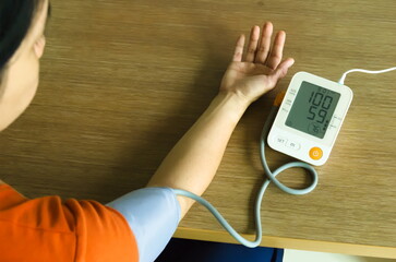 Asian Woman checking blood pressure and heart rate