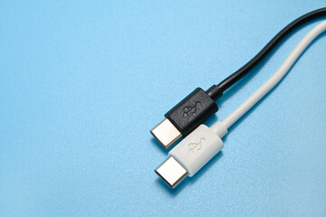 White and Black USB Type-C charger cable on a blue background.