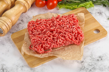 Raw minced beef meat on cutting board