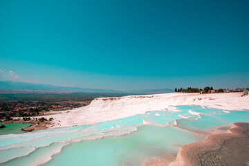 Pamukkale contains hot springs and travertines, terraces of carbonate minerals left by the flowing water.