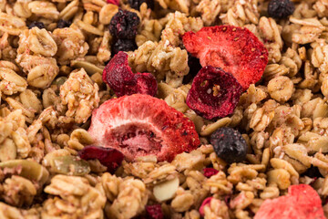 Muesli oat cereals close up background with dry fruits