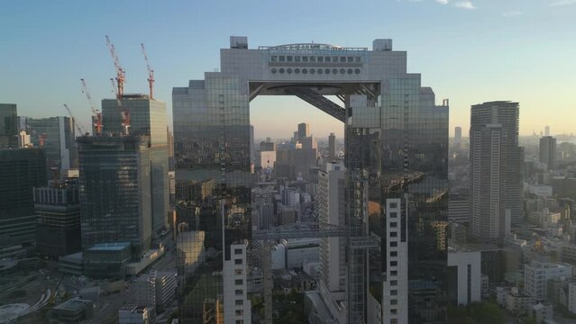 aerial pull back shot of Umeda Sky Building revealing Osaka Japan