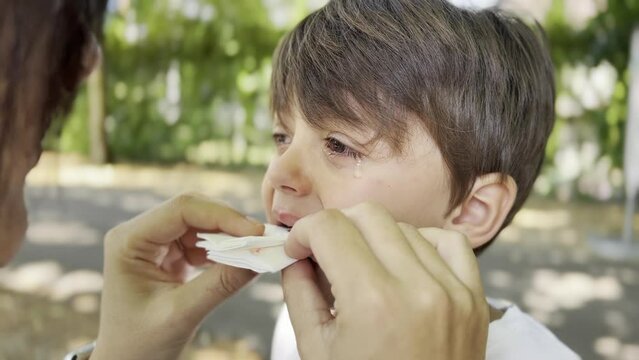 Mother Cleans Wound and Stops Bleeding from Young Boy's Gum as He Cries and Suffers from Teething, Maternal Care and Common Childhood Discomfort