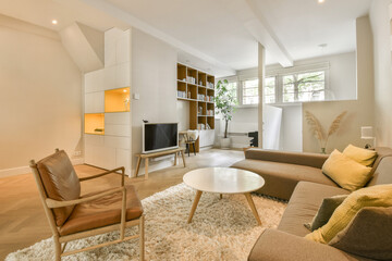 a living room with couches, chairs and a coffee table in the center of the room is white walls