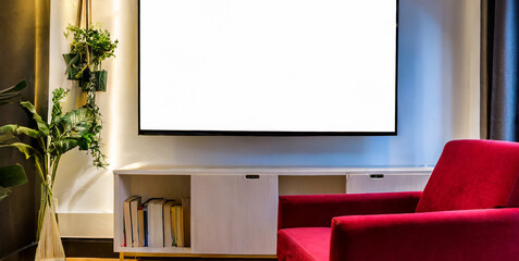 mockup a tv wall mounted with red armchair in living room with a white wall 