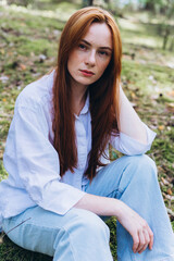 Obraz premium Beautiful woman natural face freckles casual female portrait lifestyle beauty girl. Outdoor girl portrait in green summer forest