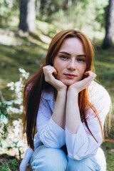 Beautiful woman natural face freckles casual female portrait lifestyle beauty girl. Outdoor girl portrait in green summer forest