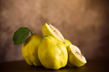 Ripe natural autumn quince on wooden table.