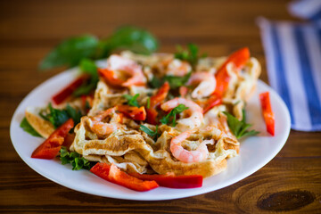Fried simple omelet with shrimp and vegetables in a plate.