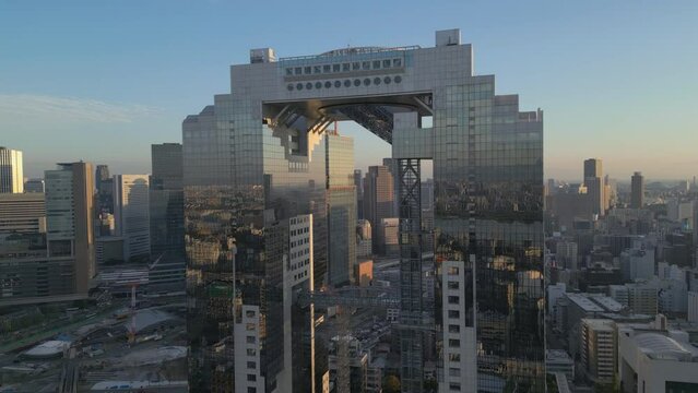 alt aerial pull back shot of Umeda Sky Building revealing Osaka Japan