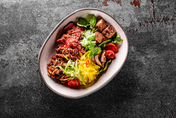 Donburi bowl with beef meat and vegetables on table