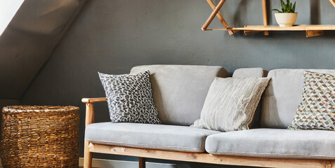 Fototapeta na wymiar sofa and lounge chair against grey wall with rustic shelves scandinavian home interior desig 