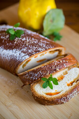 Cooked sweet pie with quince and pumpkin inside, yeast dough roll.