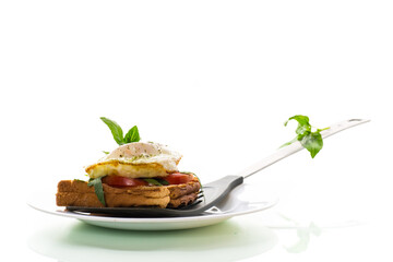 Prepared toast sandwich with fried egg with spices and herbs.