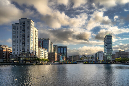 Modern architecture, tall building with restaurants, offices and apartments illuminated by sunlight in Grand Canal, Dublin docklands, Ireland
