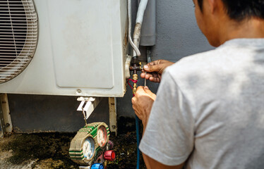 The electrician repairing the air conditioner, Technician is checking the coolness air compressor
