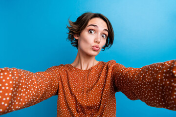 Photo portrait of pretty young girl selfie photo pouted lips dressed stylish brown outfit isolated on blue color background
