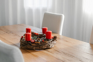 Handmade modern advent wreath with four candles lit every sunday before christmas. Traditional diy christmas decoration.