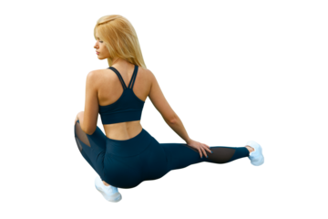 Fit woman in sitting on the floor isolated on white. Slim attractive female with flat belly relaxed or stretching