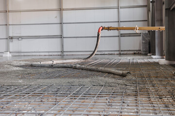 Closeup pipe of pump truck move concrete to reinforced structures, foundation of floor with Iron frame, cement building site