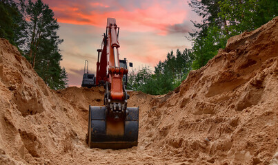 Excavator dig trench at forest area on amazing sunset background. Backgoe on earthwork for laying crude oil and natural gas pipeline or water main pipes. Construction the sewage and drainage
 - obrazy, fototapety, plakaty