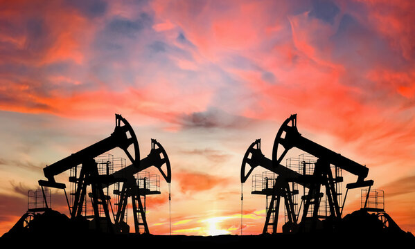 Oil prices on global market. Crude oil Pumpjack on oilfield on sunset. Fossil crude production. Oil drill rig and drilling derrick. Global crude oil Prices, petroleum demand OPEC+. Pump jack, oilfield