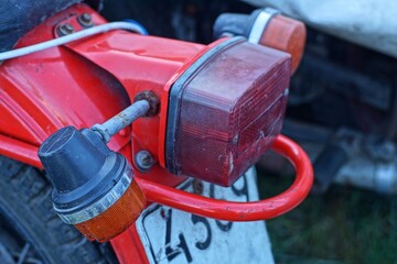 
rear red plastic old brake light with light bulb and orange side plastic turn signal with part of...