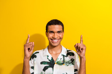 Photo of toothy beaming man with nose piercing dressed print shirt introduce discount empty space isolated on yellow color background
