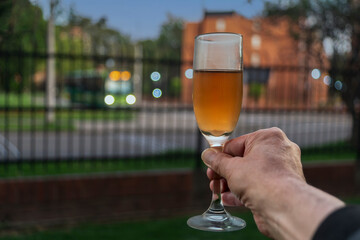 Hand holding a glass of champagne Christmas holiday and new year toast concept