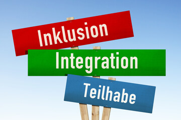 Kartonschilder mit den Aufschriften, Inklusion, Integration, Teilhabe