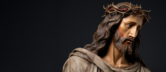 Sculpture of Jesus Christ with a crown of thorns with copy space on black background - obrazy, fototapety, plakaty