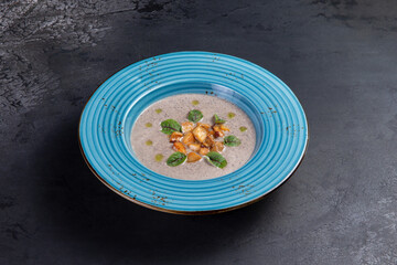 Cream of mushroom soup. On a dark background.