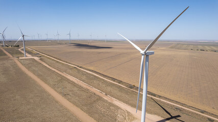 Windmill park in the countryside on a sunny day. Wind turbines in Argentina © SobrevolandPatagonia