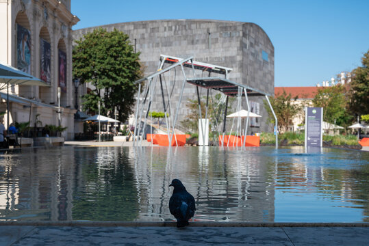 Vienna, Austria. 29 Septemner 2023. Fountain in Museum Quartier with solar panels and Mumok Museum of Modern Art in the background