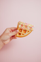 Hand Holding Waffle with sprinkles 