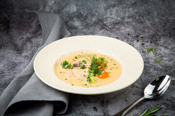 fish soup with green onions, carrots and broccoli side view