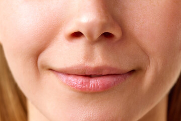 Obraz premium Cropped close-up image of female lips and smile, facial wrinkles. Natural beauty, perfect, smooth skin. Concept of natural beauty, skincare, cosmetics and cosmetology
